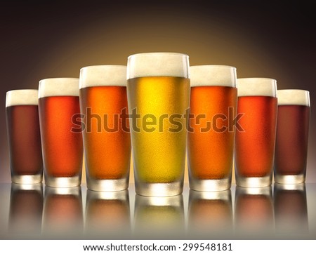 A tasty delicious row of a variety craft brew tap beers in pub glasses on reflective surface