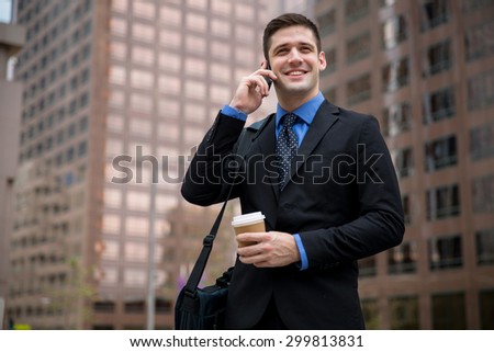 Young handsome attorney on a business call interview new job downtown skyscrapers