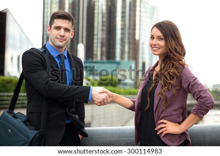 Partners clients deal handshake handsome man woman business finance relationship