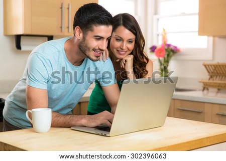 Couple husband and wife writing typing on new modern laptop computer device blogging sharing chatting