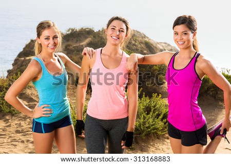 Sport fitness portrait of three beautiful ladies women athletes outdoors in nature on a jog hike