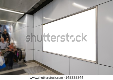 One big horizontal / landscape orientation blank billboard with escalator and passenger background