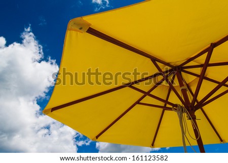 Patio umbrella against sunny blue sky