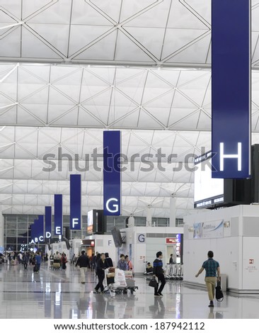 HONG KONG, CHINA - APRIL 14: Passengers in the airport main lobby on April 14, 2014 in Hong Kong, China. The Hong Kong airport handles more than 70 million passengers per year.