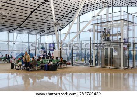 HONG KONG, CHINA - MAY 4: Passengers in the airport main lobby on MAY 4, 2015 in Hong Kong, China. The Hong Kong airport handles more than 70 million passengers per year.