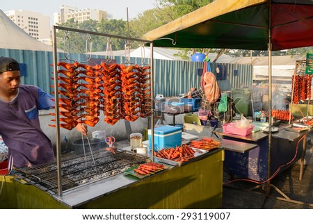 SABAH, MALAYSIA - JUL 1, 2015: Unidentified people sells roasted chicken wings at KDCA Food Stall Market in Kota Kinabalu, Sabah Borneo, Malaysia.