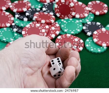 close up of a hand getting ready to roll a pair of die