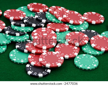 pile of betting chips winner payout on green felt