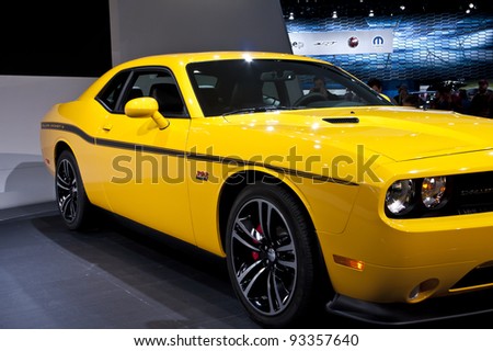 DETROIT - JANUARY 22: The Dodge SRT Challenger Yellow Jacket on display at the North American International Auto Show on January 22, 2011 in Detroit, Michigan.