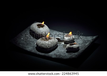 burning candles isolated on black background