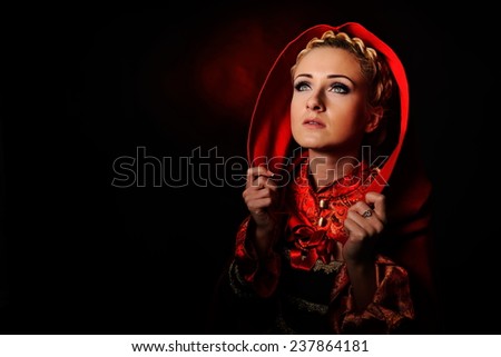 beautiful woman with red cloak in studio