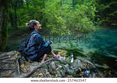 Female tourist in the forest resting