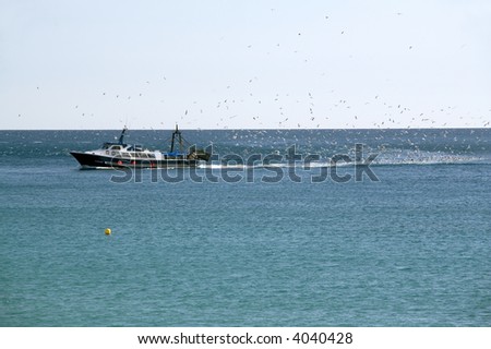 Fishing boat moving at open sea