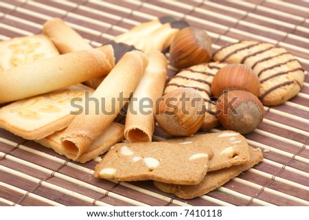 fancy cakes/biscuits and whole hazelnuts as background
