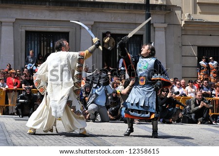 spanish people in fiesta - moors and christians - street fight