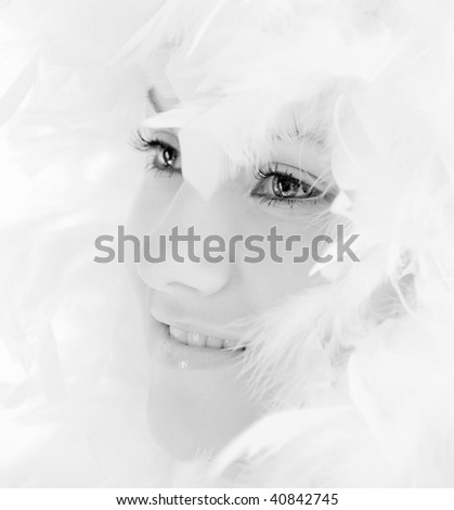 beautiful young woman with white feathers