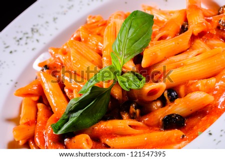 Penne pasta with a tomato sauce on plate