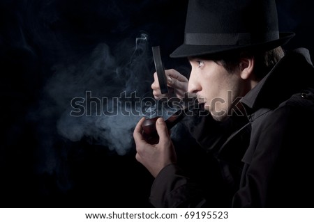 Private detective searching for information, isolated on a black background