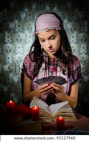 Young mystical woman playing fortune-teller