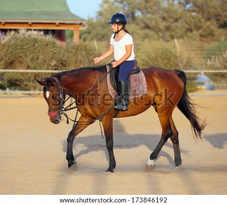 little girl is riding a horse