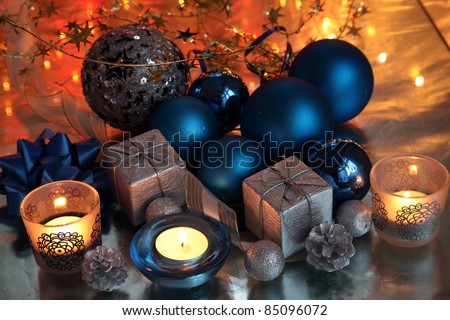 Christmas decoration with gifts,bauble,candle lights on background with twinkle lights.
