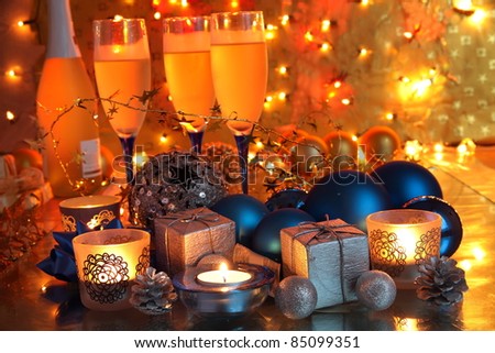 Christmas decoration with bauble,gifts,candle lights and gold background with twinkle lights.