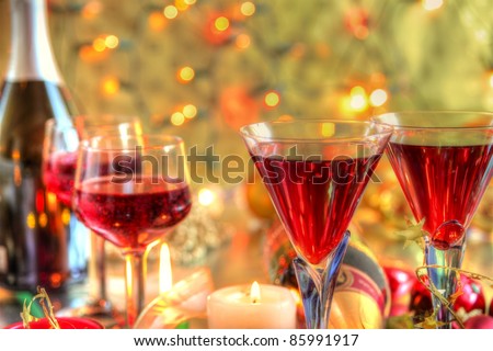 Closeup of red wine in glasses,candle lights on background with twinkle lights.