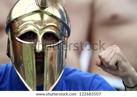 WARSAW,POLAND- JUNE 8,2012:Greek football fans wearing ancient helmets during the game between Greece and Poland for Euro 2012 in Warsaw on June 8,2012