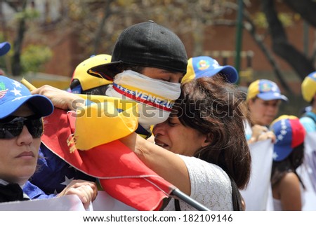 CARACAS, VENEZUELA - MARCH 16, 2014: Venezuelans protest in the street against the government for human rights violations and killings of civilians in peaceful demonstrations