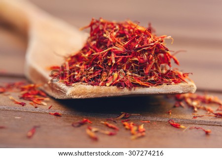 Red saffron over a wooden table