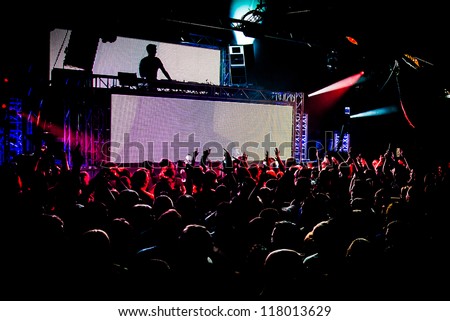 Audience Crowd Silhouette Dancing to DJ Pete Tong at Cream Nightclub Party. Nightlife Lazer Show Hands In Air