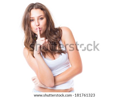 Beautiful woman with secret holding finger over lips on white background