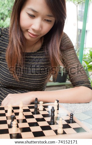 Portrait of Women playing chess outdoor