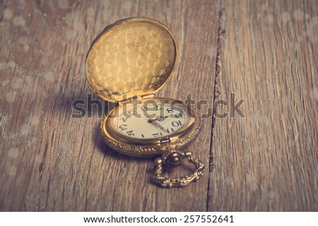 vintage pocket watch on a wooden background