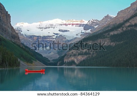 Red Voyageur Canoes Moored on Lake Louise at Dawn - Banff National Park, Alberta, Canada