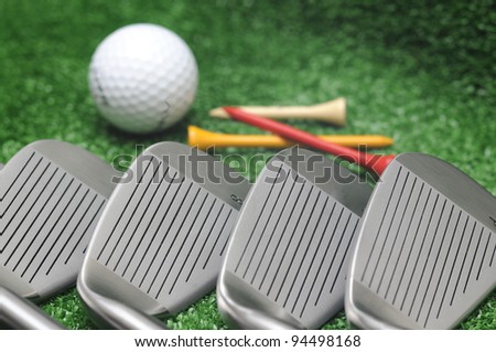 Set of golf club, tee and golf ball.