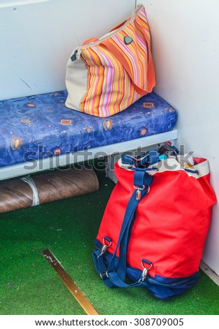 Packed summer bags on the boat, summer is over, return concept