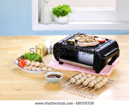 Barbecue grill on the smokeless stove in the kitchen interior