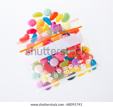 Colourful candy in the zipper bag isolated