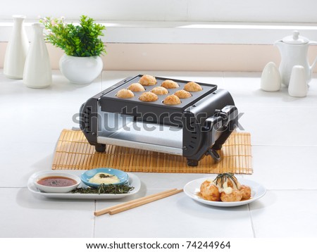 Takoyaki japanese food on stove in the kitchen interior