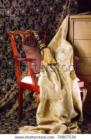 Beautiful fabric and tassel display on the wooden chair isolated