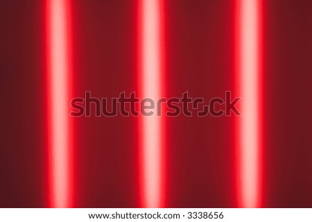 tree red strip lights behind a glass plate