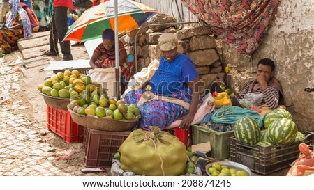 HARAR, ETHIOPIA - JULY 26,2014 - People sell vegetables on the streets of Jugul, the fortified historic walled city on UNESCO\'s World Heritage List, and considered as the fourth holy city of Islam.