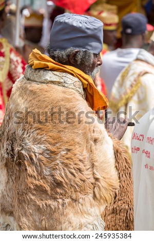 A monk wearing sheep hide patiently waits for the arrival of the tabot, representation of the arc of the covenant, during Timket (Epiphany) celebrations, on January 19, 2015 in Addis Ababa.