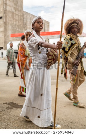 Addis Ababa - May 5: A young girl dressed in colourful traditional outfit holding a spear and shield marches at the 74th anniversary of Patriots\' Victory day on May 5, 2015 in Addis Ababa, Ethiopia.