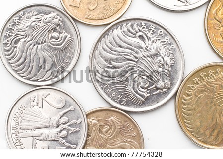 a collection of the different coins of Ethiopian currency including five, ten, twenty five and fifty cents