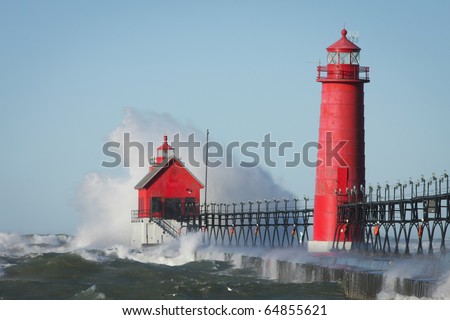Waves crashing on lighthouse. Grand Haven lighthouse on Lake Michigan. Horizontal format.