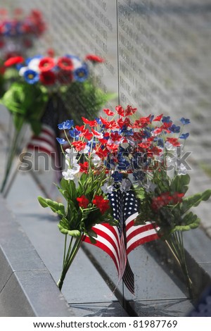 Vietnam Wall Memorial Flowers and Flag in Washington, DC