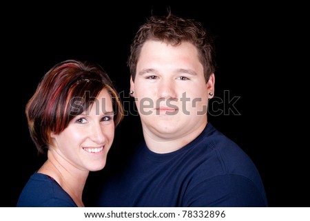 An isolated image of a young man and woman couple.  They are wearing blank t shirts so any text can be entered by the buyer.
