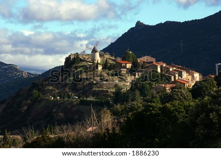 Scenic view of french village Cucugnan with a mill on the hill.